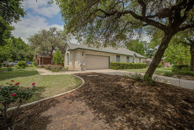 view of front of property featuring concrete driveway, stone siding, a front lawn, and a garage