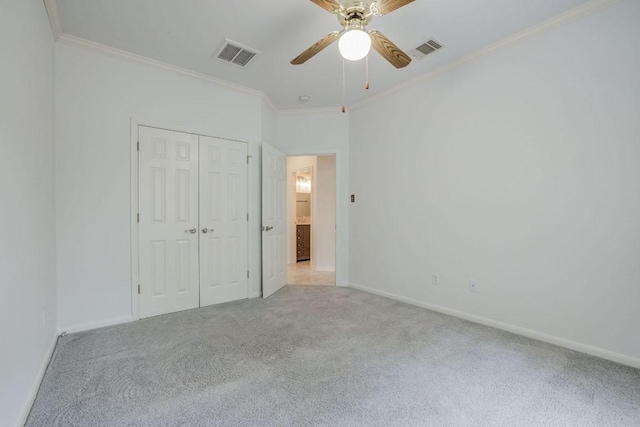 unfurnished bedroom with light colored carpet, visible vents, and ornamental molding