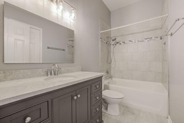 full bath featuring toilet, shower / bath combination, and vanity