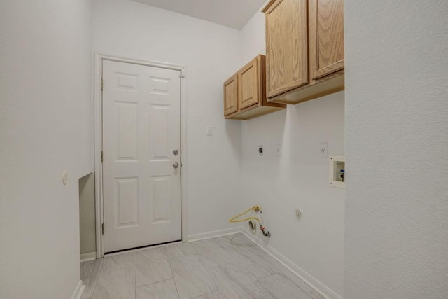 laundry area featuring gas dryer hookup, electric dryer hookup, baseboards, hookup for a washing machine, and cabinet space