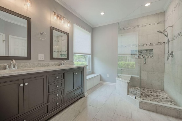 bathroom with ornamental molding, a stall shower, double vanity, and a sink