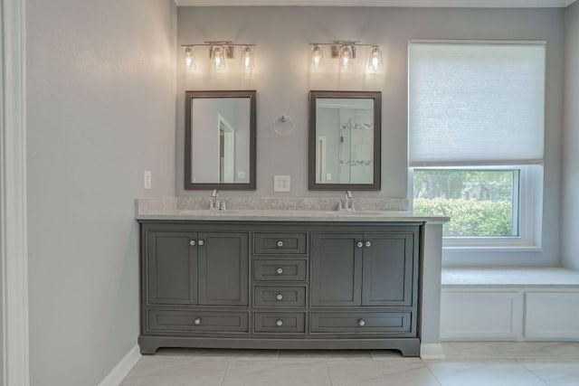bathroom with tile patterned floors, double vanity, and a sink