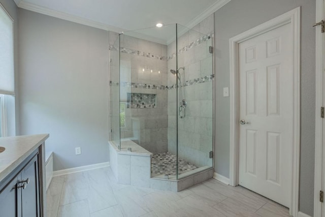 full bathroom featuring vanity, a shower stall, crown molding, and baseboards