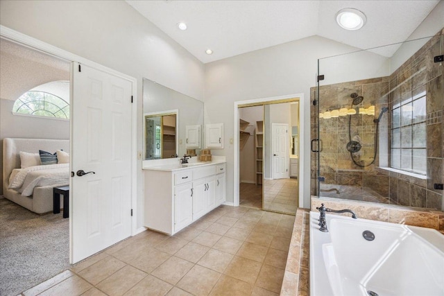 9007 Tweed Berwick Dr, Austin, TX 78750 - bathroom with vanity, tile patterned floors, high vaulted ceiling, a shower stall, and a garden tub