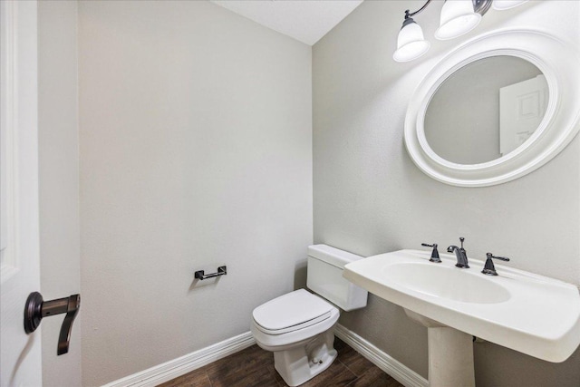 9007 Tweed Berwick Dr, Austin, TX 78750 - bathroom featuring wood finished floors, baseboards, and toilet