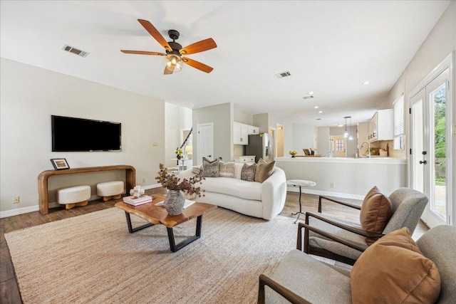 9007 Tweed Berwick Dr, Austin, TX 78750 - living room featuring a ceiling fan, baseboards, visible vents, and light wood finished floors