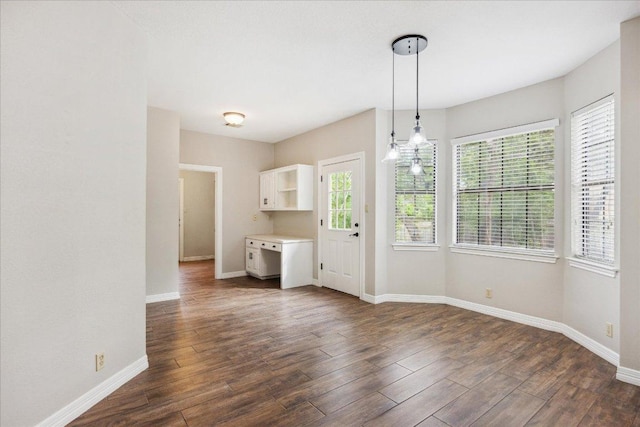 9007 Tweed Berwick Dr, Austin, TX 78750 - unfurnished dining area featuring baseboards and dark wood finished floors