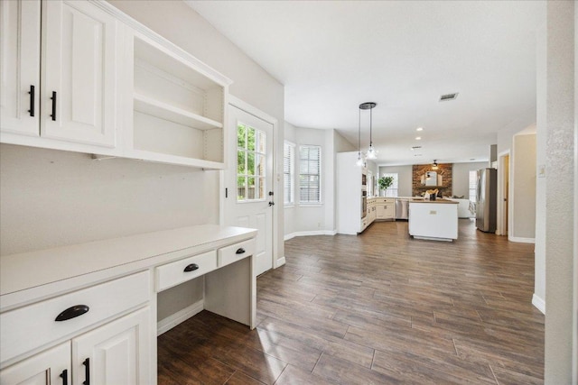 9007 Tweed Berwick Dr, Austin, TX 78750 - interior space with visible vents, dark wood-style flooring, baseboards, and stainless steel appliances