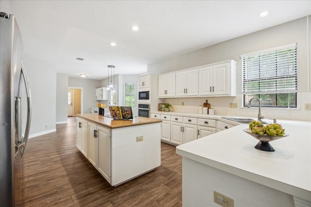 9007 Tweed Berwick Dr, Austin, TX 78750 - kitchen with recessed lighting, a sink, appliances with stainless steel finishes, and a kitchen island