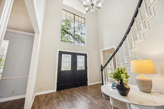 9007 Tweed Berwick Dr, Austin, TX 78750 - foyer featuring a chandelier, stairs, baseboards, wood finished floors, and a towering ceiling