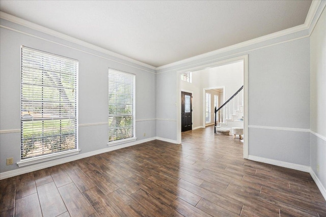 9007 Tweed Berwick Dr, Austin, TX 78750 - spare room featuring dark wood-style flooring, baseboards, ornamental molding, and stairway