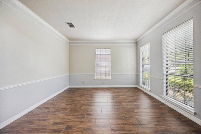 9007 Tweed Berwick Dr, Austin, TX 78750 - spare room featuring visible vents, dark wood-type flooring, a textured ceiling, and crown molding