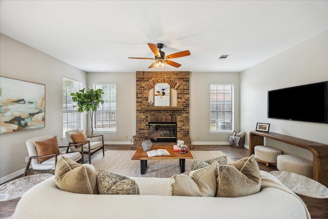 9007 Tweed Berwick Dr, Austin, TX 78750 - living room with ceiling fan, a fireplace, baseboards, and wood finished floors