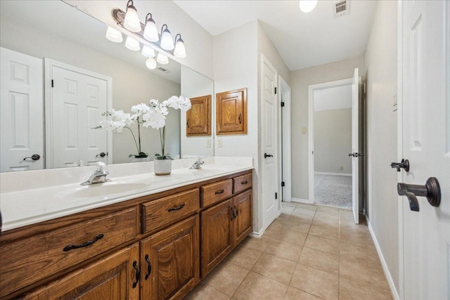 9007 Tweed Berwick Dr, Austin, TX 78750 - full bathroom featuring double vanity, visible vents, a sink, baseboards, and tile patterned floors