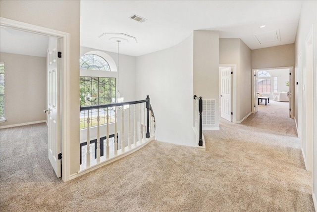 9007 Tweed Berwick Dr, Austin, TX 78750 - hall with attic access, visible vents, an upstairs landing, and carpet