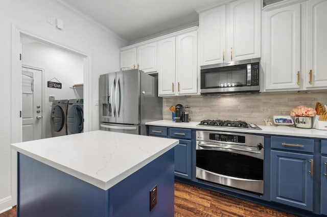 108 Perpetuation Dr, Austin, TX 78734 - kitchen featuring appliances with stainless steel finishes, blue cabinets, washing machine and clothes dryer, decorative backsplash, and ornamental molding