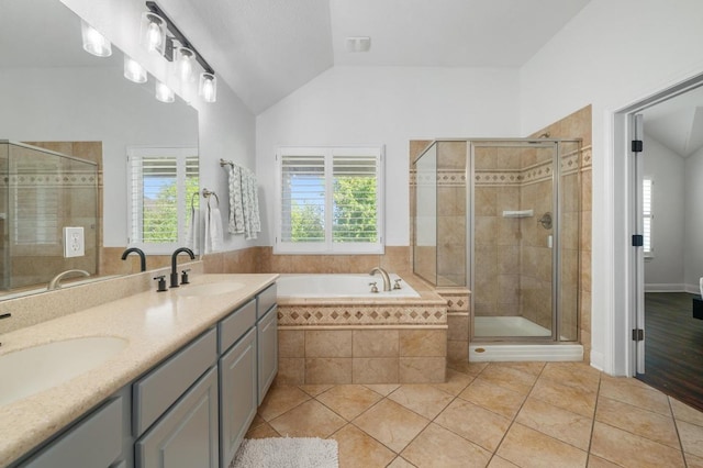 108 Perpetuation Dr, Austin, TX 78734 - full bathroom featuring lofted ceiling, a stall shower, tile patterned flooring, a bath, and double vanity