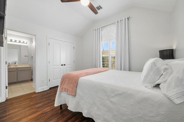 108 Perpetuation Dr Unit 802, Lakeway, TX 78734 - bedroom with lofted ceiling, wood finished floors, ensuite bath, a ceiling fan, and a closet