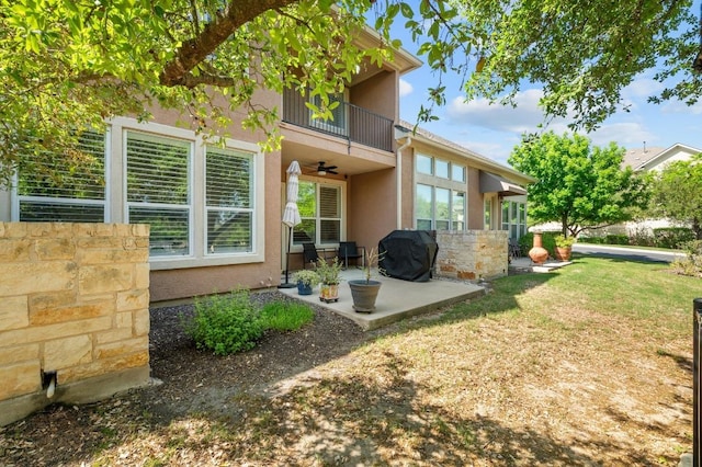 108 Perpetuation Dr Unit 802, Lakeway, TX 78734 - rear view of property with a balcony, stucco siding, a ceiling fan, a patio area, and a lawn