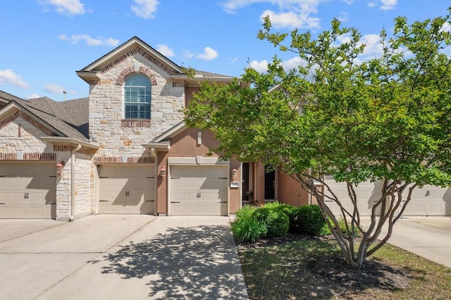 108 Perpetuation Dr Unit 802, Lakeway, TX 78734 - view of front of house featuring stone siding, concrete driveway, and an attached garage