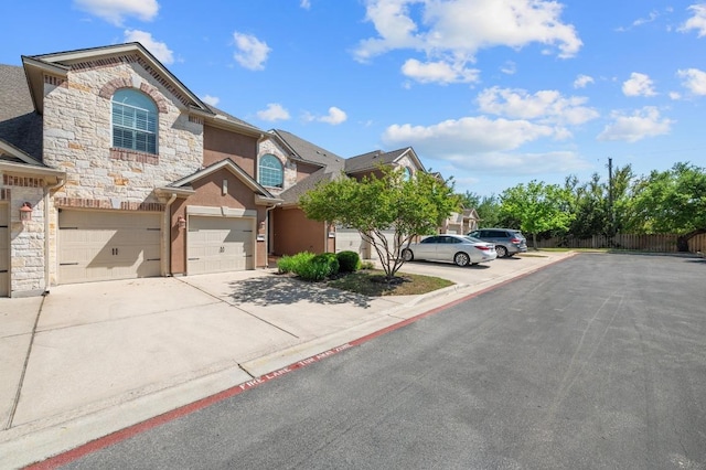 108 Perpetuation Dr, Austin, TX 78734 - view of front of house with stone siding, stucco siding, concrete driveway, and an attached garage