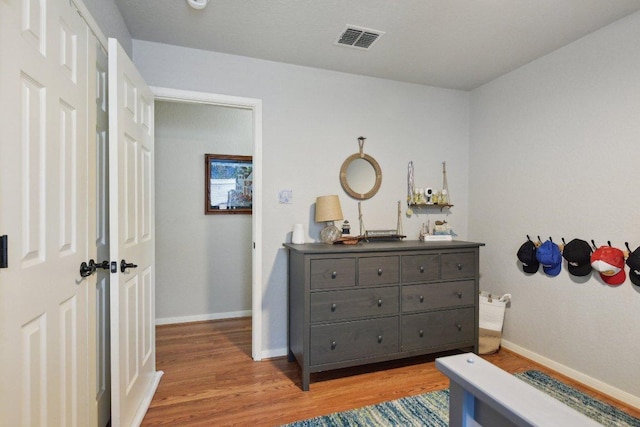 bedroom with baseboards, visible vents, and light wood-style flooring