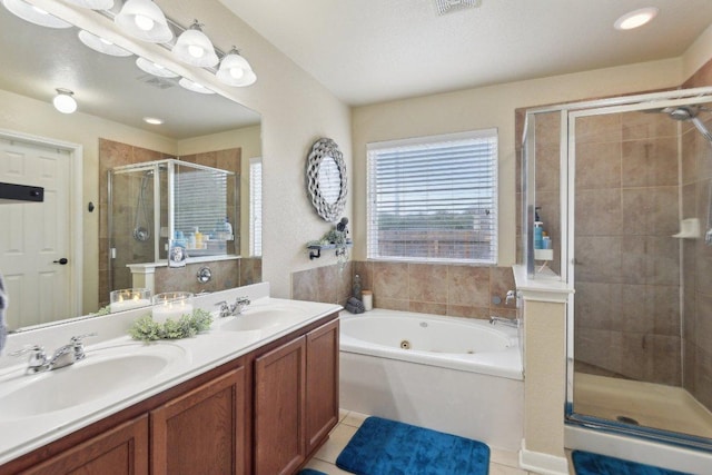 full bathroom featuring a shower stall, double vanity, a whirlpool tub, and a sink