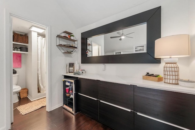 1107 Maufrais St, Austin, TX 78703 - indoor dry bar with dark wood-style flooring, vaulted ceiling, wine cooler, and a ceiling fan