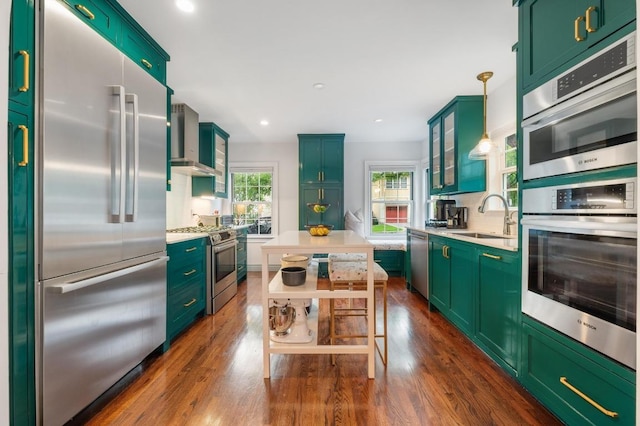 1107 Maufrais St, Austin, TX 78703 - kitchen featuring stainless steel appliances, wall chimney range hood, light countertops, dark wood-style flooring, and recessed lighting