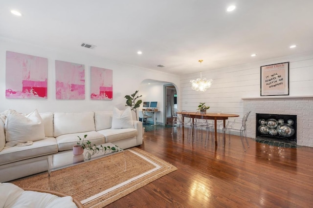 1107 Maufrais St, Austin, TX 78703 - living area with arched walkways, wood finished floors, a chandelier, recessed lighting, and crown molding
