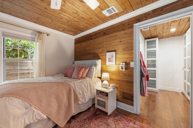 1107 Maufrais St, Austin, TX 78703 - bedroom featuring wood ceiling, wood walls, wood finished floors, and crown molding