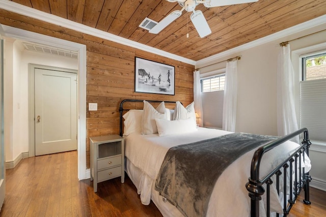 1107 Maufrais St, Austin, TX 78703 - bedroom featuring crown molding, wood ceiling, multiple windows, wooden walls, and hardwood / wood-style flooring