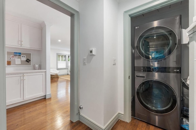 1107 Maufrais St, Austin, TX 78703 - laundry room featuring stacked washing machine and dryer and wood finished floors