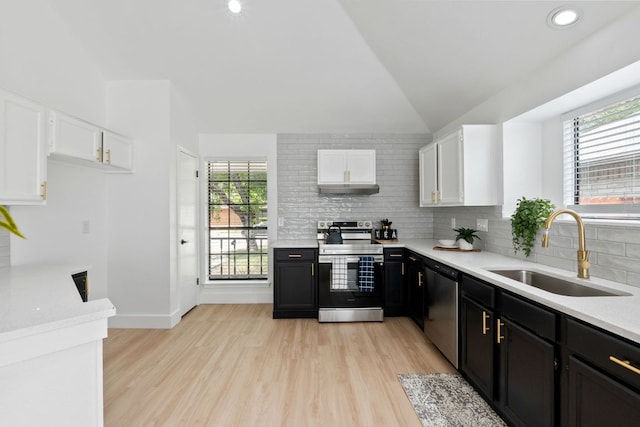 609 Clearwater Trl, Round Rock, TX 78664 - kitchen with stainless steel appliances, a sink, lofted ceiling, light countertops, and white cabinets