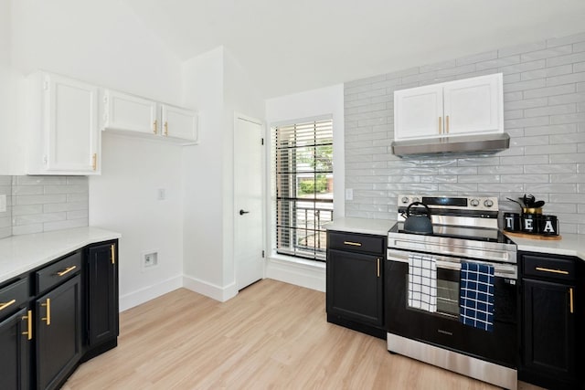 609 Clearwater Trl, Round Rock, TX 78664 - kitchen with stainless steel electric range, white cabinetry, light countertops, and lofted ceiling