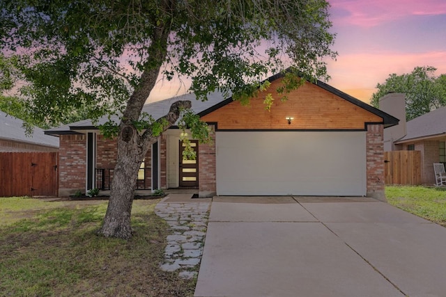 609 Clearwater Trl, Round Rock, TX 78664 - view of front of home with concrete driveway, brick siding, an attached garage, and a gate