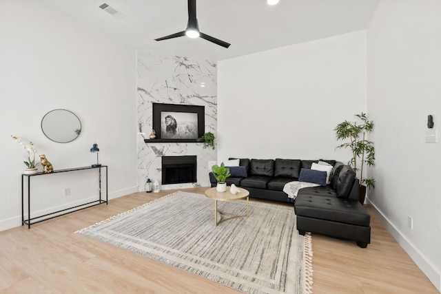 609 Clearwater Trl, Round Rock, TX 78664 - living room with a ceiling fan, wood finished floors, baseboards, and a premium fireplace