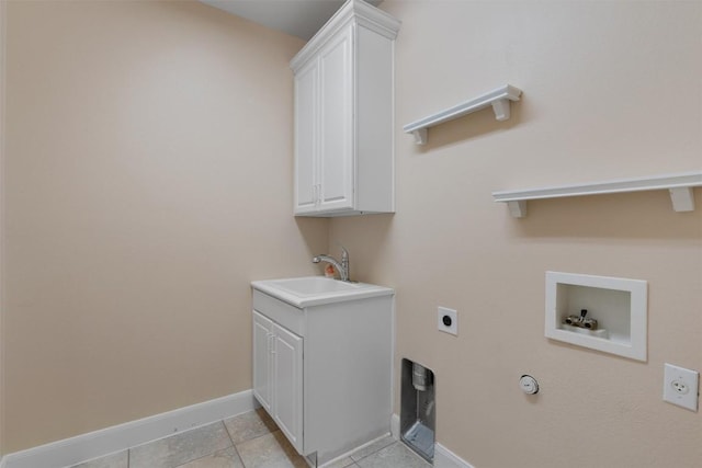 202 Goose Island Dr, Georgetown, TX 78633 - laundry room featuring hookup for an electric dryer, hookup for a washing machine, cabinet space, light tile patterned floors, and baseboards