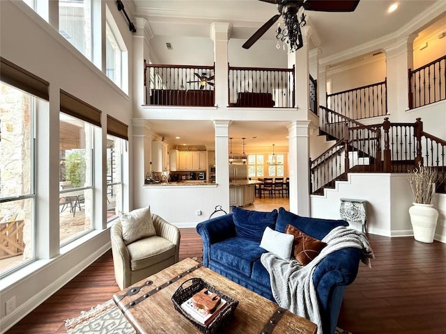 804 Lakewood Hills Ter, Austin, TX 78732 - living room with a ceiling fan, healthy amount of natural light, crown molding, and a towering ceiling