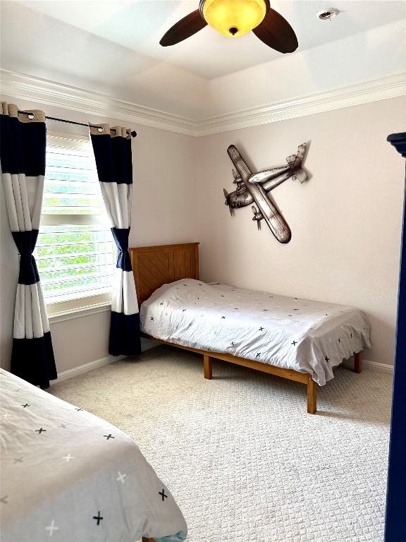 804 Lakewood Hills Ter, Austin, TX 78732 - carpeted bedroom featuring ornamental molding, baseboards, ceiling fan, and a tray ceiling