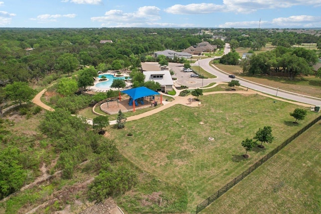 birds eye view of property featuring a view of trees