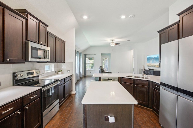 kitchen with a sink, stainless steel appliances, a center island, dark brown cabinetry, and light countertops