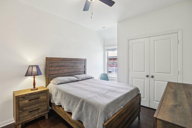 bedroom with a closet, ceiling fan, vaulted ceiling, and dark wood finished floors