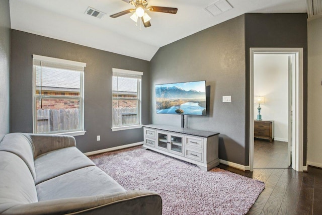 living room with lofted ceiling, visible vents, a ceiling fan, and baseboards
