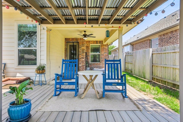 wooden terrace featuring fence and ceiling fan
