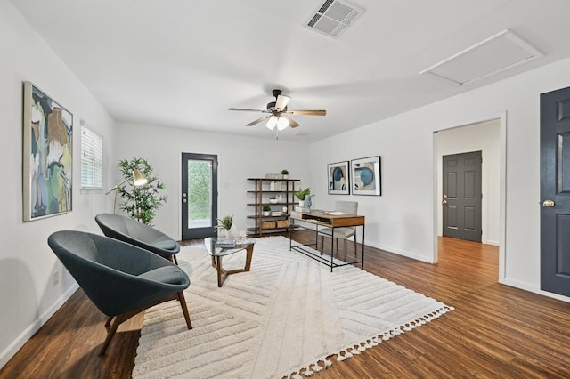 living area with a ceiling fan, baseboards, visible vents, and wood finished floors
