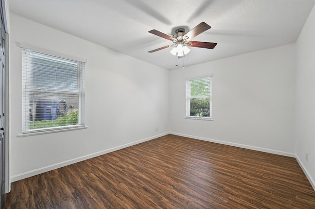 spare room with a ceiling fan, baseboards, and wood finished floors