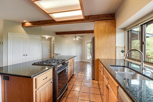 kitchen with beamed ceiling, a sink, stainless steel appliances, a center island, and backsplash