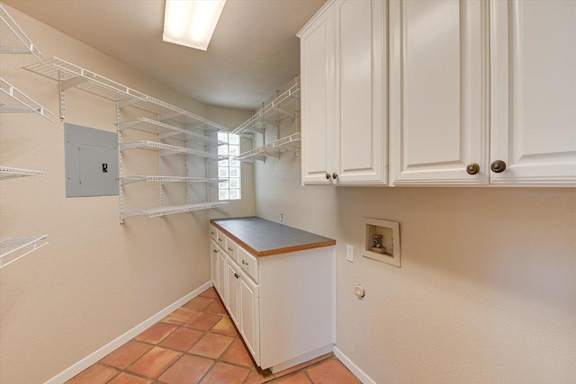 5000 High Canyon Pass, Austin, TX 78738 - laundry room featuring electric panel, cabinet space, hookup for a washing machine, and light tile patterned floors