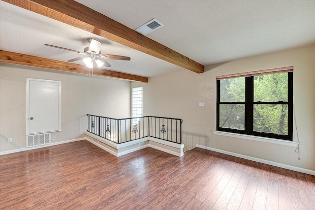 5000 High Canyon Pass, Austin, TX 78738 - empty room featuring wood finished floors, beamed ceiling, healthy amount of natural light, and a ceiling fan